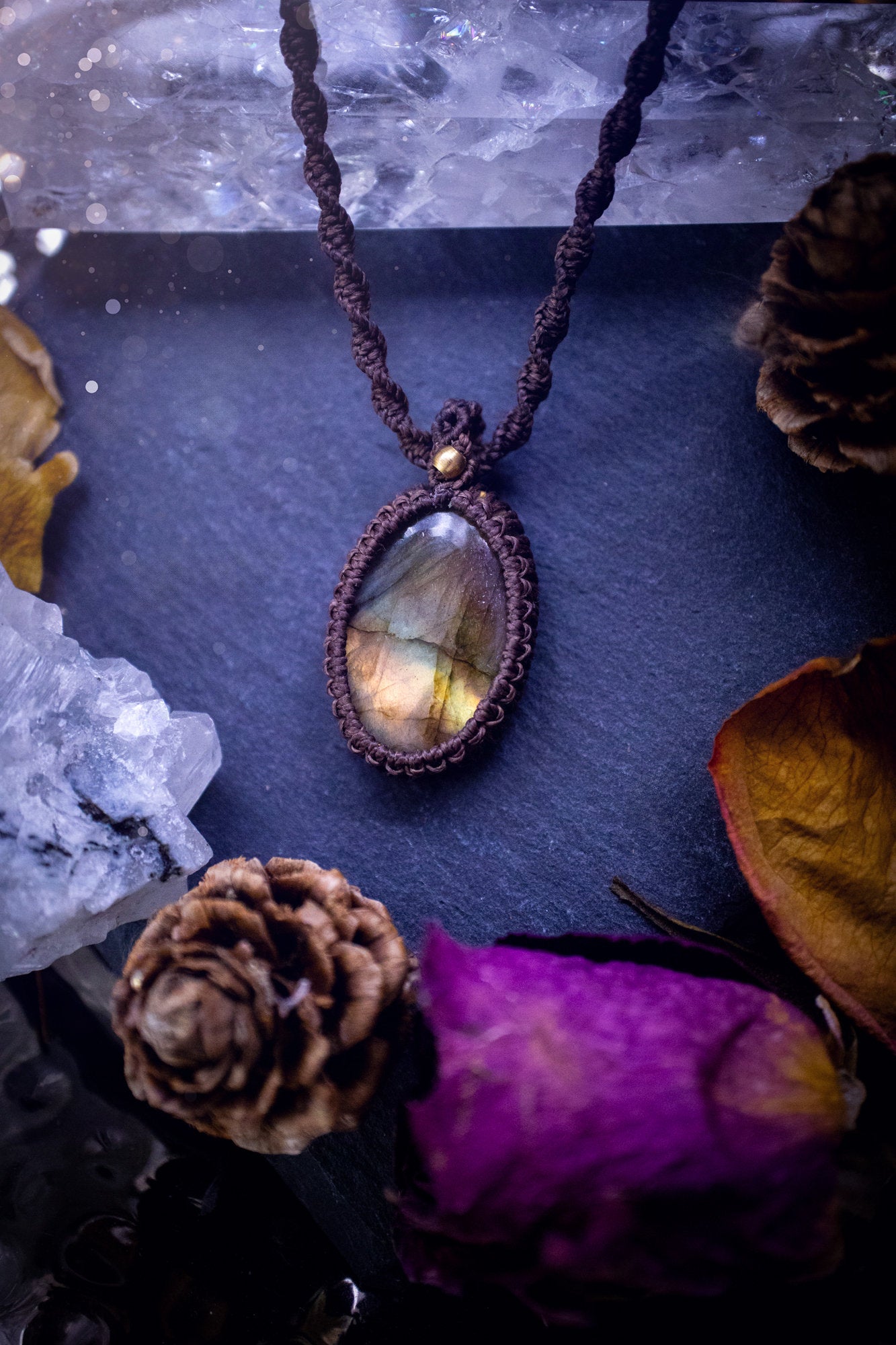 Handmade, autumn coloured labradorite macrame pendant necklace. Featuring a beautiful labradorite crystal which is full of orange, yellow and purple colours. Crafted with high quality linhastia wax cord, and accents on the necklace. Hippy gifts