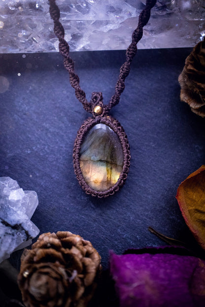 Handmade, autumn coloured labradorite macrame pendant necklace. Featuring a beautiful labradorite crystal which is full of orange, yellow and purple colours. Crafted with high quality linhastia wax cord, and accents on the necklace. Hippy gifts