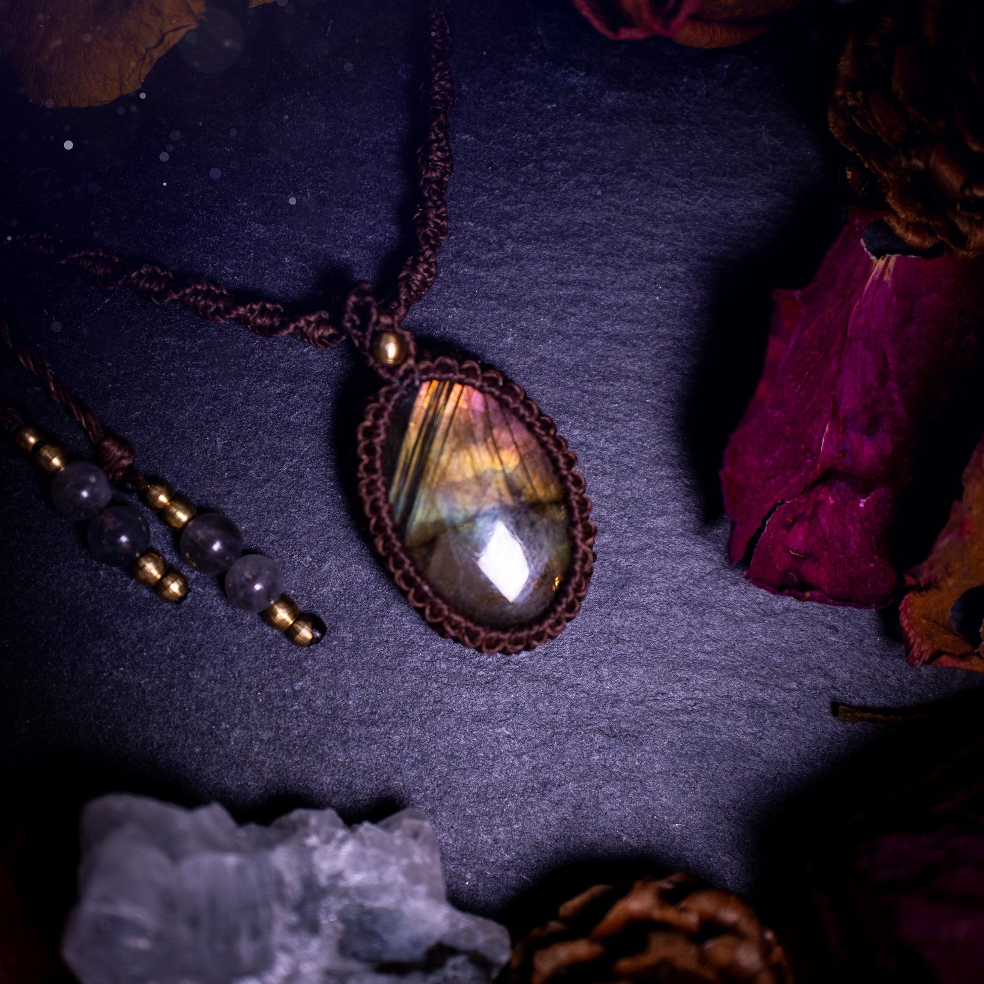 Handmade, autumn coloured labradorite macrame pendant necklace. Featuring a beautiful labradorite crystal which is full of orange, yellow and purple colours. Crafted with high quality linhastia wax cord, and accents on the necklace. Hippy gifts