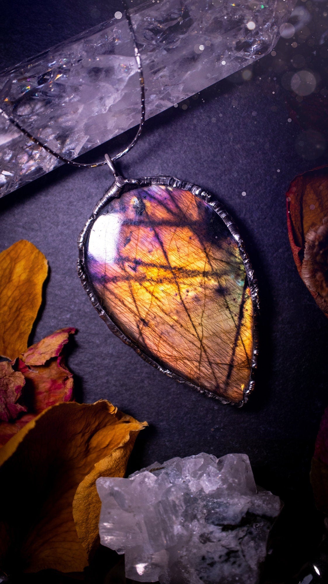 Beautiful, orange, pink and purple labradorite crystal which has been soft soldered to create a stunning pendant. Natural crystal gemstone with lead free solder, a beautiful gift for any crystal lover. This piece of jewellery can be used for healing