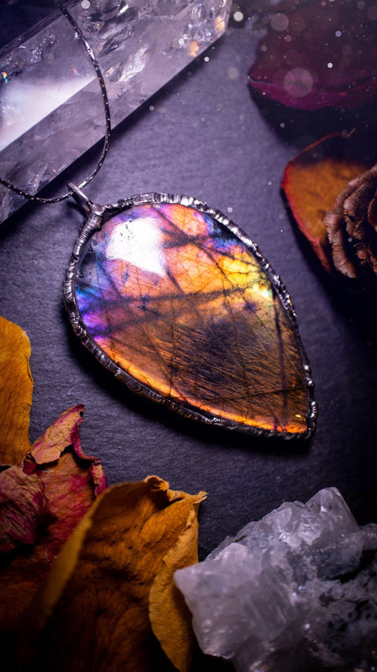 Beautiful, orange, pink and purple labradorite crystal which has been soft soldered to create a stunning pendant. Natural crystal gemstone with lead free solder, a beautiful gift for any crystal lover. This piece of jewellery can be used for healing