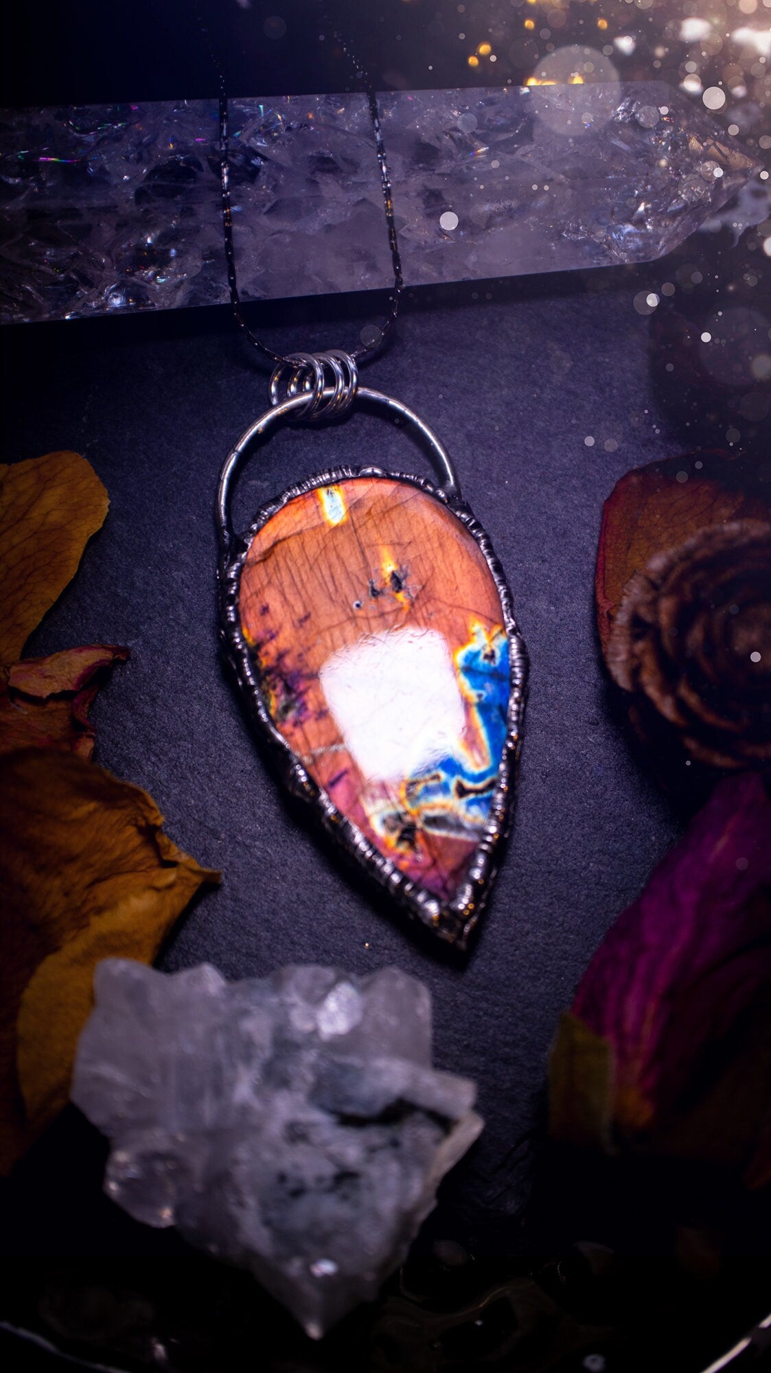 Beautiful, orange, pink and purple labradorite crystal which has been soft soldered to create a stunning pendant. Natural crystal gemstone with lead free solder, a beautiful gift for any crystal lover. This piece of jewellery can be used for healing