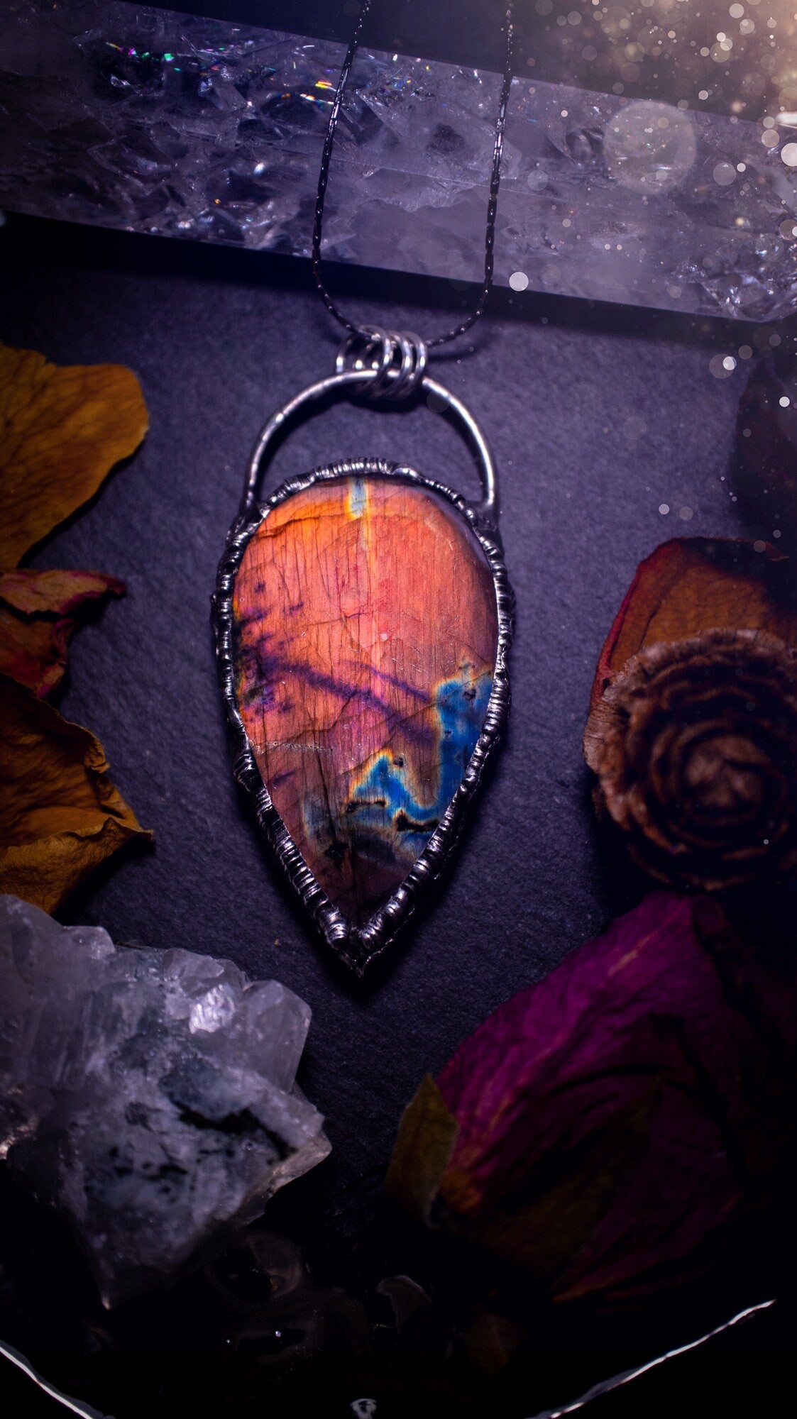 Beautiful, orange, pink and purple labradorite crystal which has been soft soldered to create a stunning pendant. Natural crystal gemstone with lead free solder, a beautiful gift for any crystal lover. This piece of jewellery can be used for healing