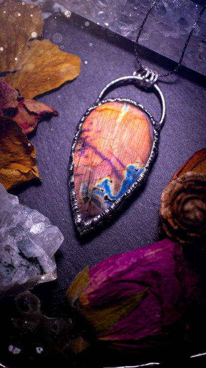 Beautiful, orange, pink and purple labradorite crystal which has been soft soldered to create a stunning pendant. Natural crystal gemstone with lead free solder, a beautiful gift for any crystal lover. This piece of jewellery can be used for healing