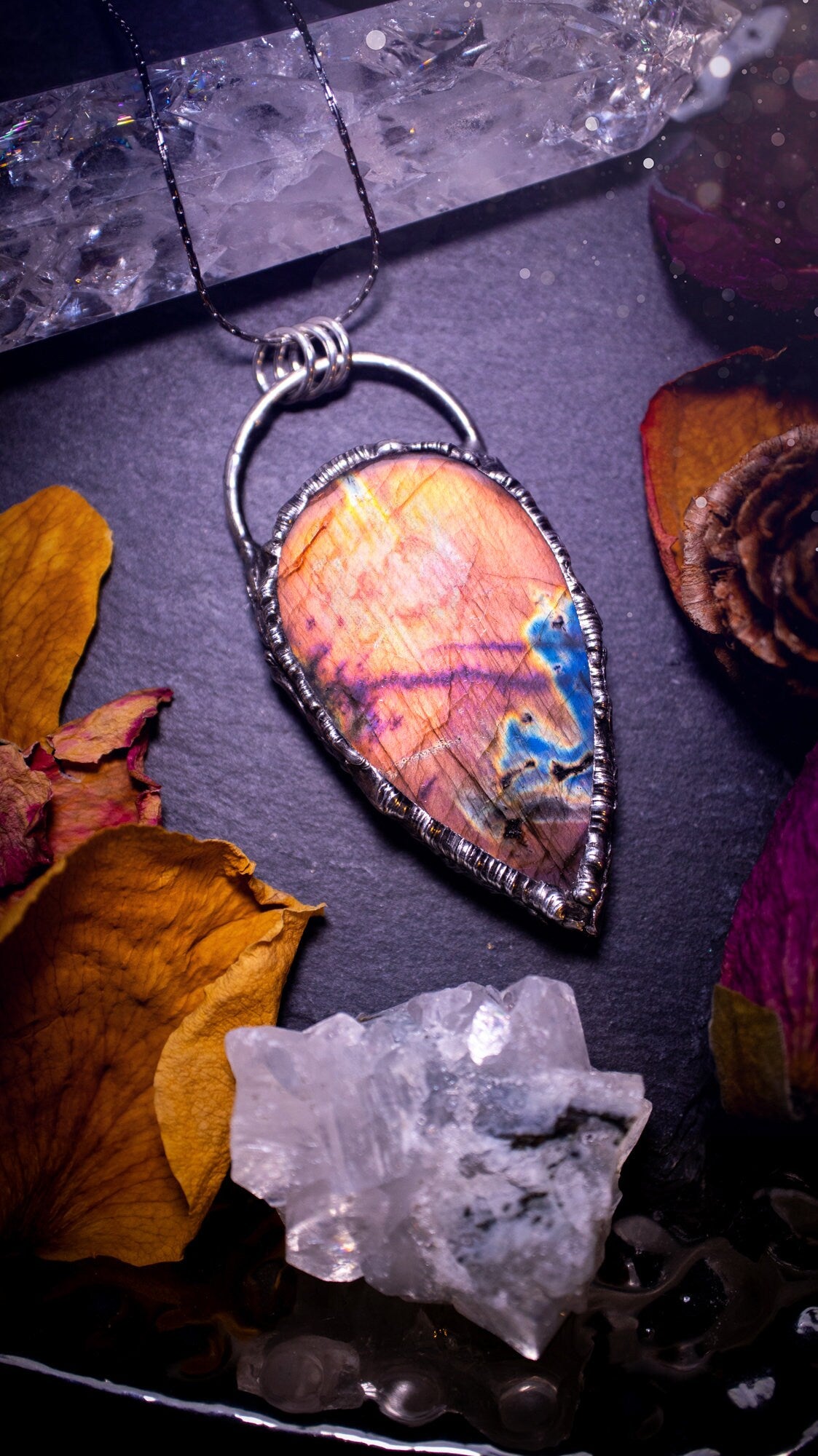 Beautiful, orange, pink and purple labradorite crystal which has been soft soldered to create a stunning pendant. Natural crystal gemstone with lead free solder, a beautiful gift for any crystal lover. This piece of jewellery can be used for healing