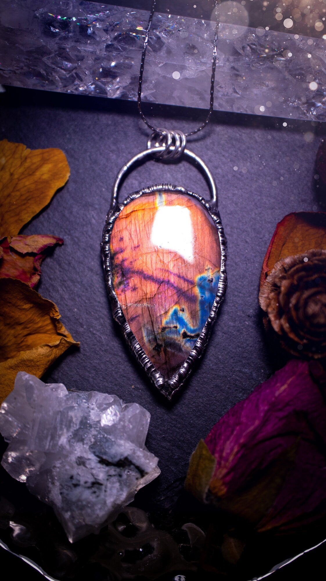 Beautiful, orange, pink and purple labradorite crystal which has been soft soldered to create a stunning pendant. Natural crystal gemstone with lead free solder, a beautiful gift for any crystal lover. This piece of jewellery can be used for healing