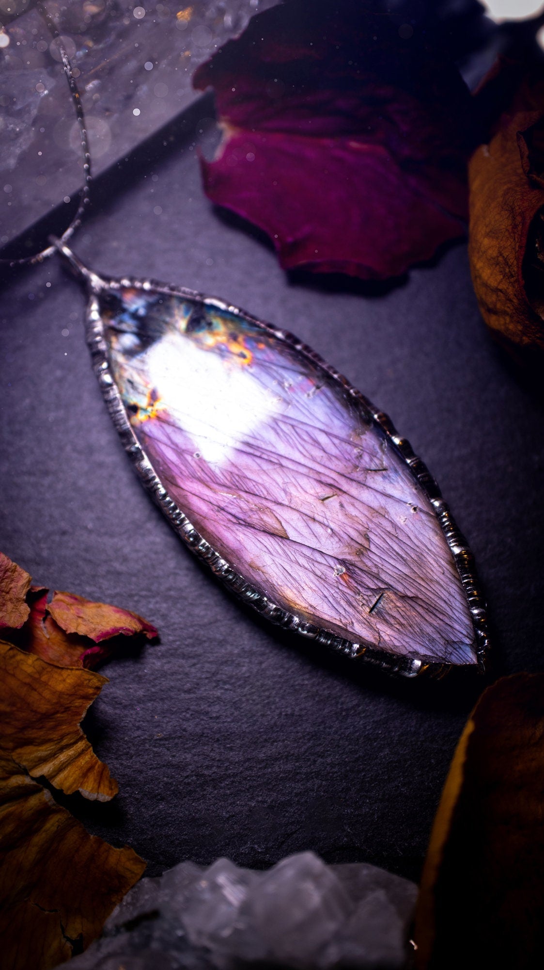 Beautiful, orange, pink and purple labradorite crystal which has been soft soldered to create a stunning pendant. Natural crystal gemstone with lead free solder, a beautiful gift for any crystal lover. This piece of jewellery can be used for healing