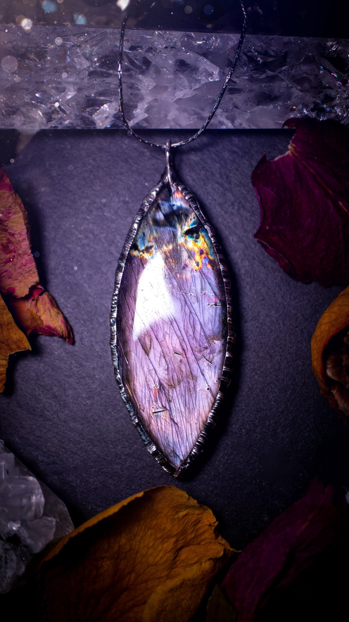 Beautiful, orange, pink and purple labradorite crystal which has been soft soldered to create a stunning pendant. Natural crystal gemstone with lead free solder, a beautiful gift for any crystal lover. This piece of jewellery can be used for healing