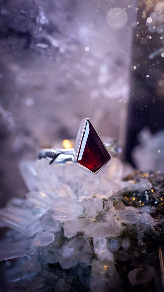 Beautiful and bold, garnet statement ring. Although this ring is dainty, it will certainly make a statement. Featuring a lovely red garnet crystal which is step cut, and mounted in sterling silver on a stamped ring band. Ideal crystal gifts for her