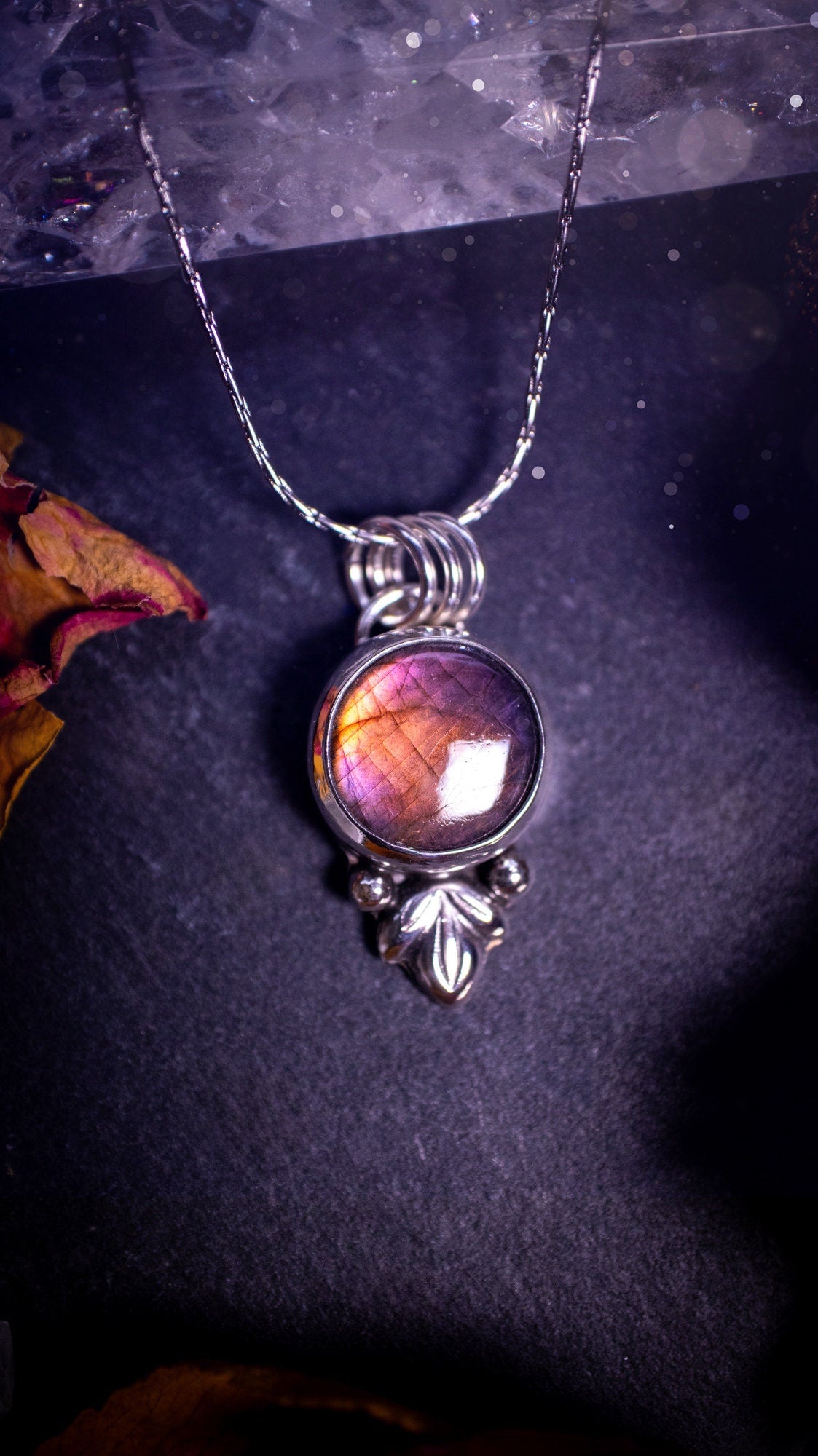 Gorgeous and handmade, sterling silver, purple and orange, labradorite spectrolite pendant necklace. This beautiful necklace features a beautiful labradorite crystal full of colour. Handcrafted from sterling silver that has been recycled. Ideal gift.