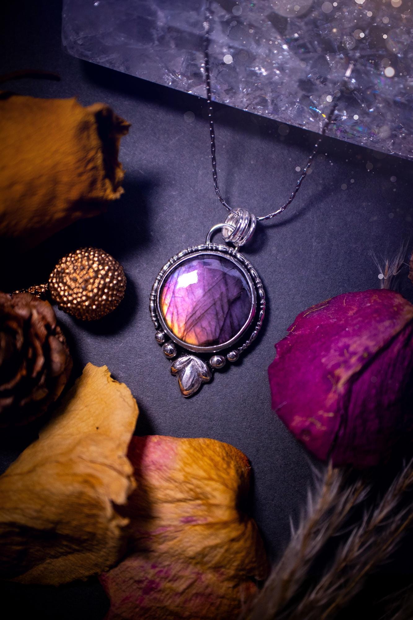 Beautiful and handmade, natural pink, purple and orange labradorite, crystal pendant necklace. This necklace has been made from fine and sterling silver and features silver leaf and ball components. The ideal gift for crystal lovers. Hippy, gothic.