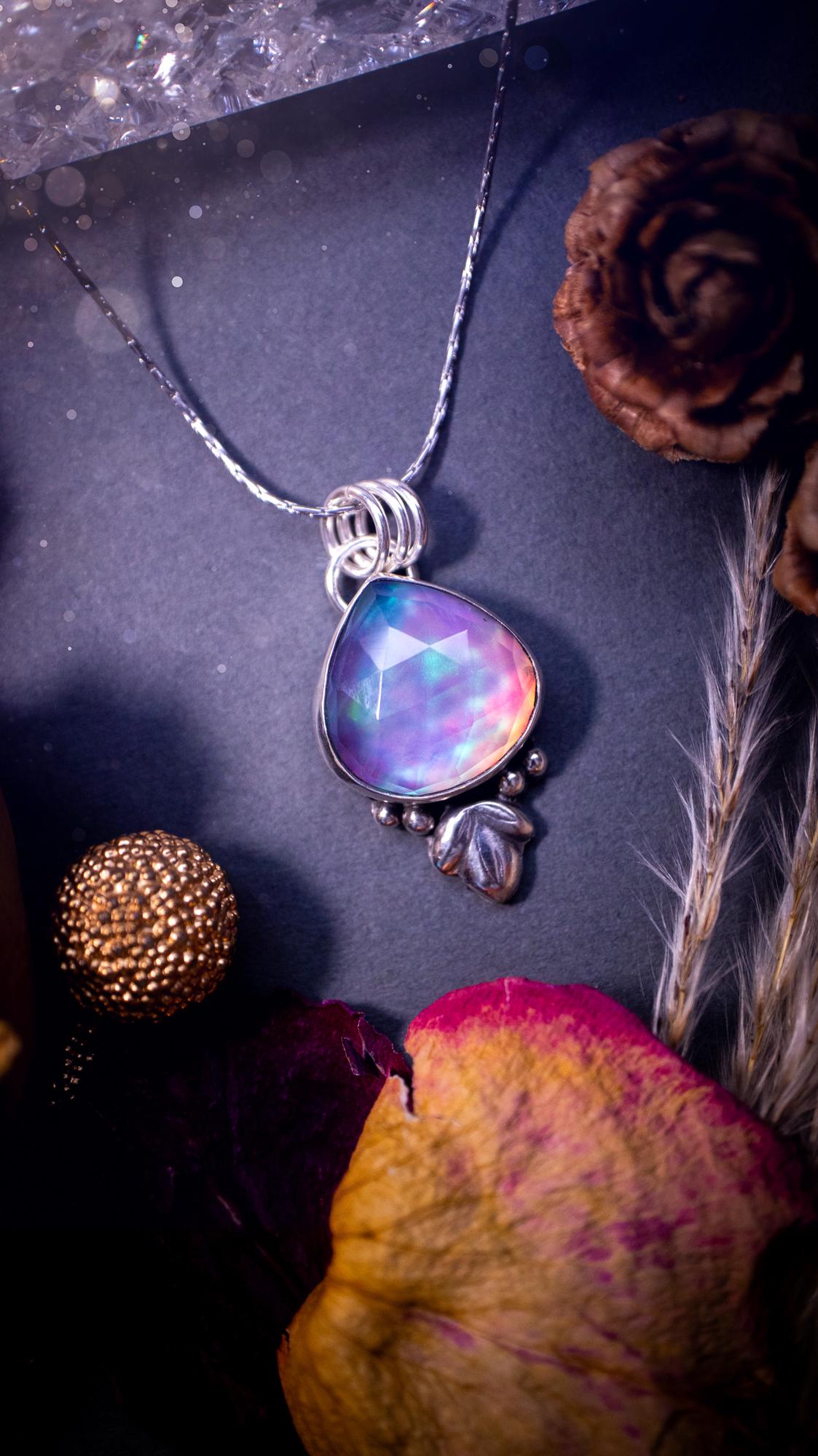 Beautiful Aurora opal sterling silver pendant necklace. This beautiful stone has an array of flashes from pinks, greens, and blues. Set in sterling silver and fine silver, this handmade piece is ideal for special occasion gifts and crystal lovers.