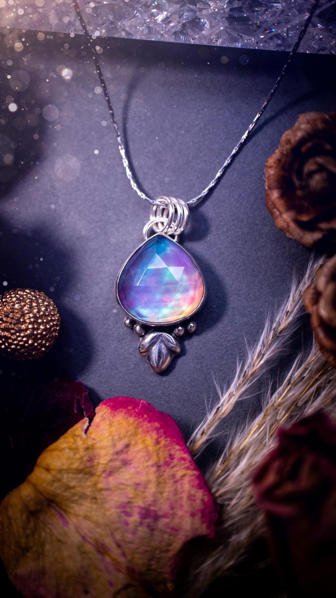 Beautiful Aurora opal sterling silver pendant necklace. This beautiful stone has an array of flashes from pinks, greens, and blues. Set in sterling silver and fine silver, this handmade piece is ideal for special occasion gifts and crystal lovers.