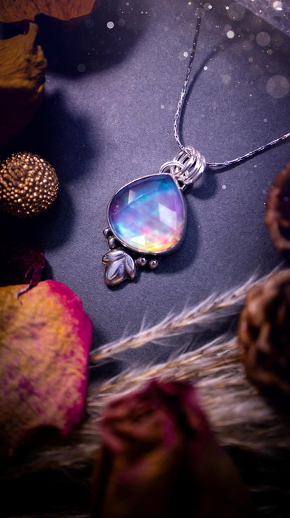 Beautiful Aurora opal sterling silver pendant necklace. This beautiful stone has an array of flashes from pinks, greens, and blues. Set in sterling silver and fine silver, this handmade piece is ideal for special occasion gifts and crystal lovers.