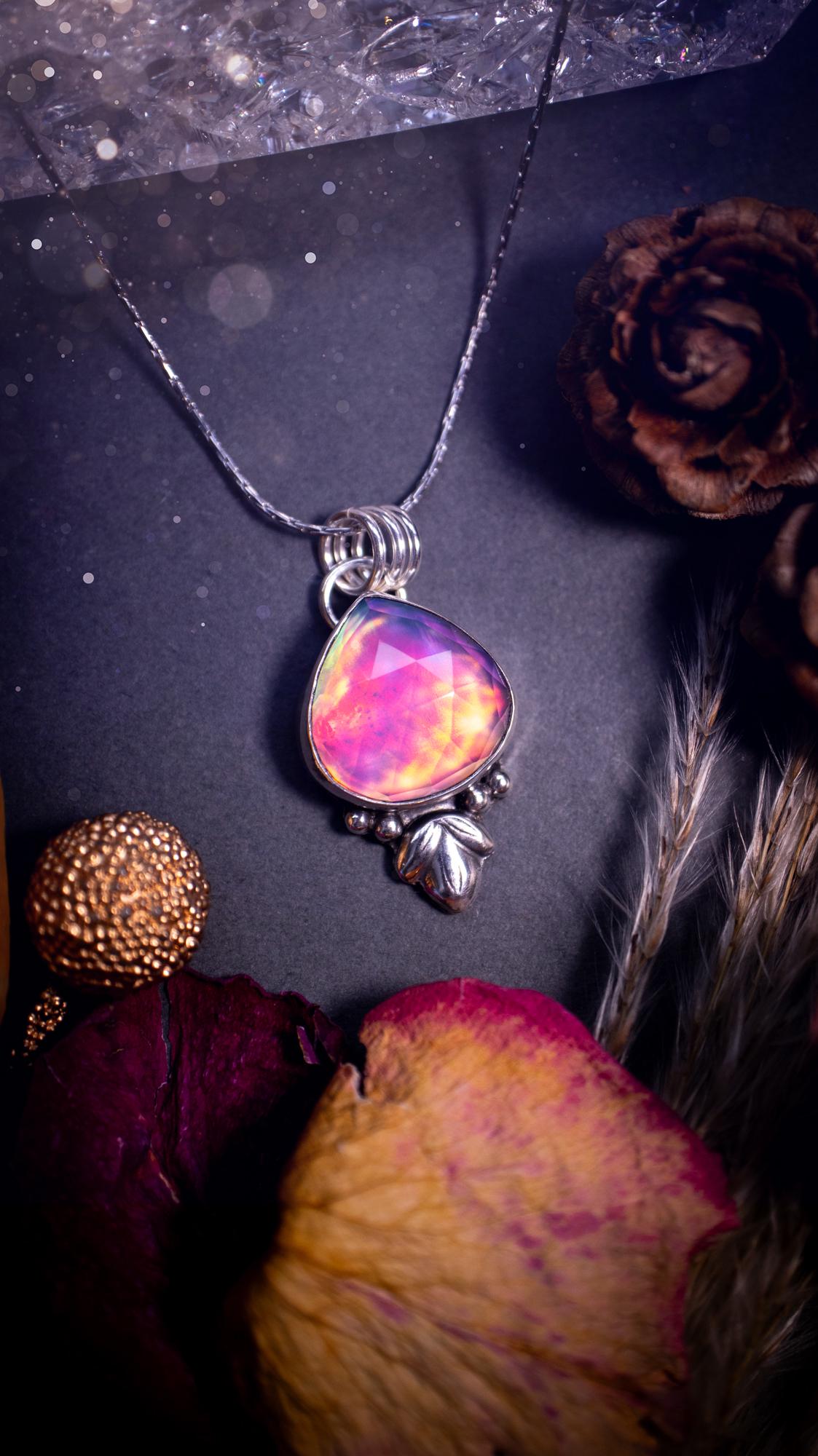 Beautiful Aurora opal sterling silver pendant necklace. This beautiful stone has an array of flashes from pinks, greens, and blues. Set in sterling silver and fine silver, this handmade piece is ideal for special occasion gifts and crystal lovers.