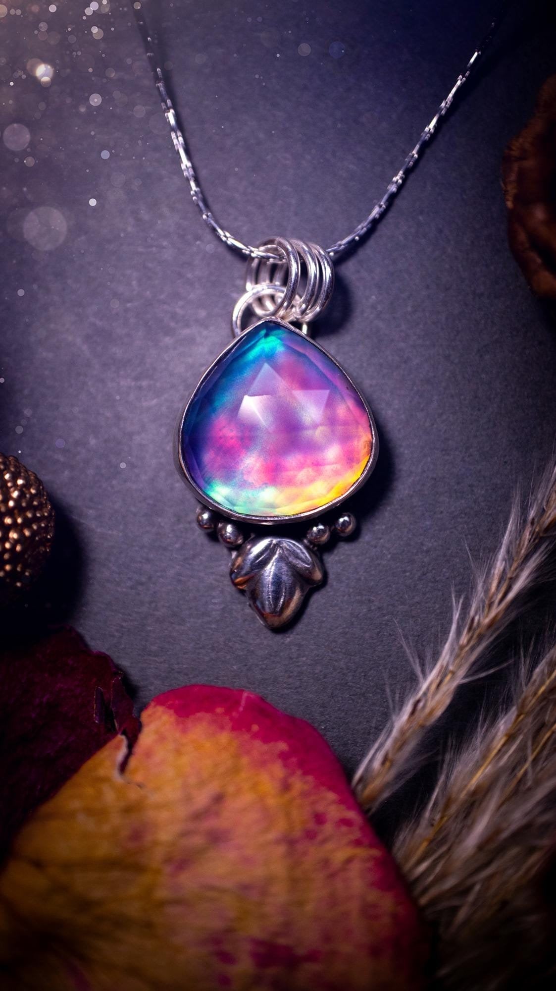 Beautiful Aurora opal sterling silver pendant necklace. This beautiful stone has an array of flashes from pinks, greens, and blues. Set in sterling silver and fine silver, this handmade piece is ideal for special occasion gifts and crystal lovers.