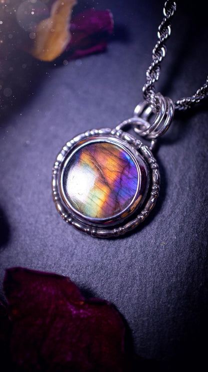 Beautifully handcrafted, dainty purple, orange, green and pink Labradorite spectrolite pendant necklace. This circular labradorite is full of stunning colour and patterns which has been made into a pendant using recycled sterling silver. Crystal gift