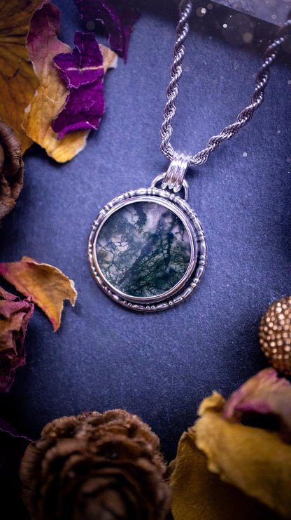 Beautifully handmade, dainty, moss agate crystal pendant necklace. This circular moss agate is full of stunning colour and patterns which has been made into a pendant using recycled sterling silver. Crystal gifts, gothic and hippy jewellery.