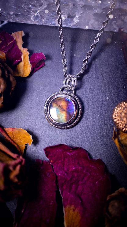 Beautifully handcrafted, dainty purple, orange, green and pink Labradorite spectrolite pendant necklace. This circular labradorite is full of stunning colour and patterns which has been made into a pendant using recycled sterling silver. Crystal gift