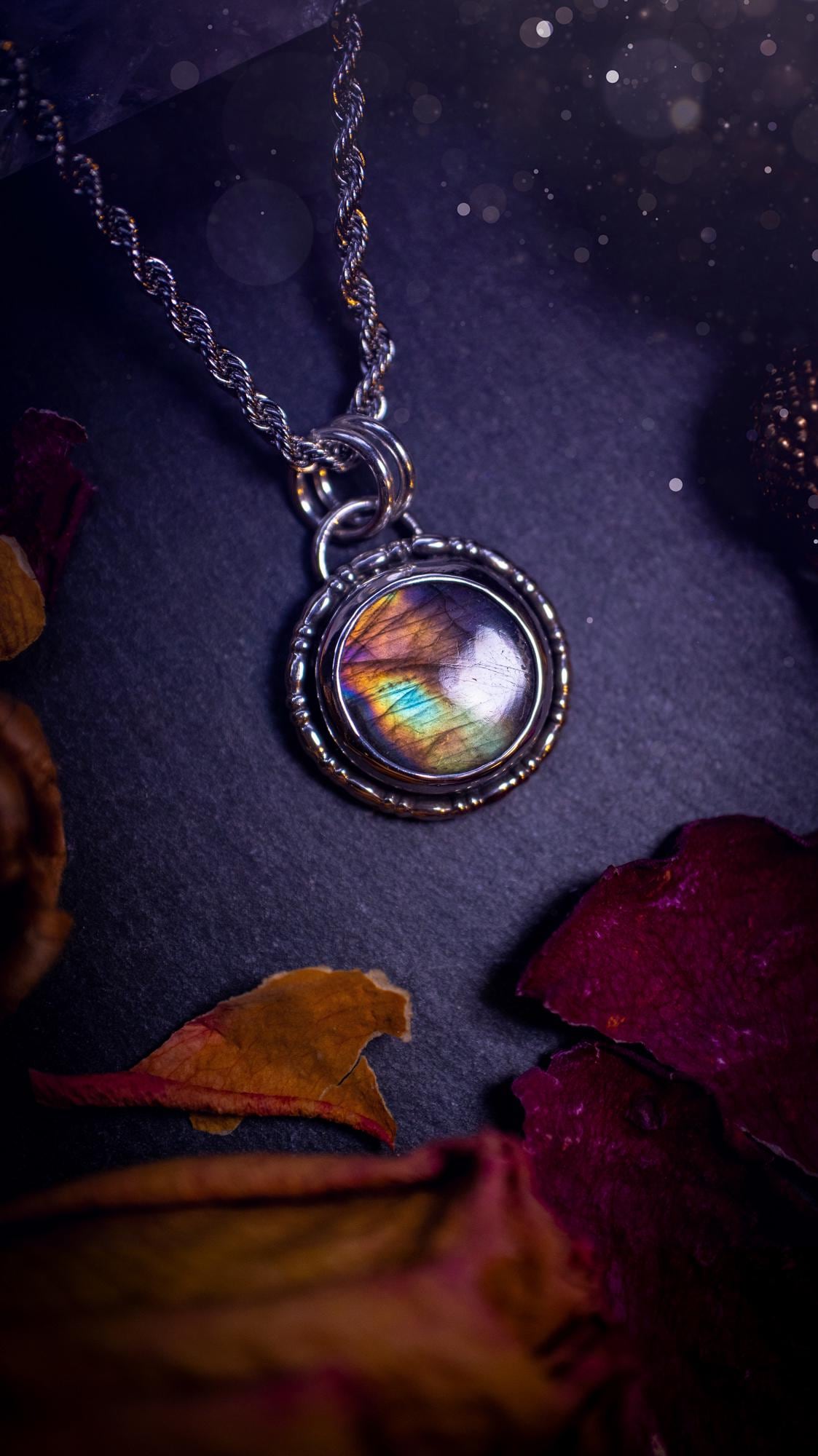 Beautifully handcrafted, dainty purple, orange, green and pink Labradorite spectrolite pendant necklace. This circular labradorite is full of stunning colour and patterns which has been made into a pendant using recycled sterling silver. Crystal gift