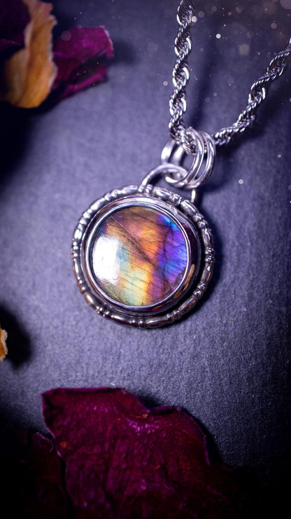 Beautifully handcrafted, dainty purple, orange, green and pink Labradorite spectrolite pendant necklace. This circular labradorite is full of stunning colour and patterns which has been made into a pendant using recycled sterling silver. Crystal gift