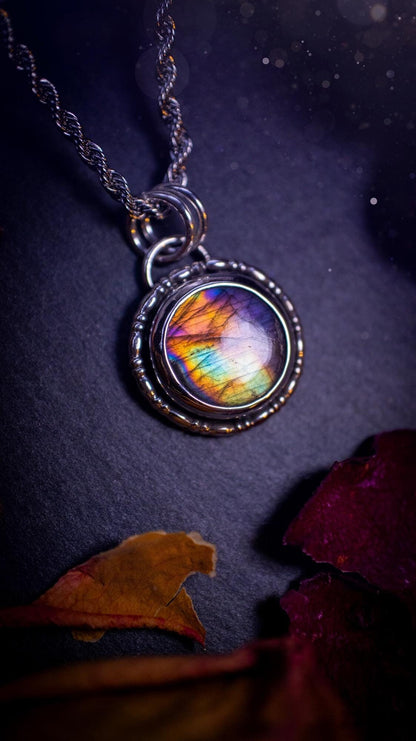 Beautifully handcrafted, dainty purple, orange, green and pink Labradorite spectrolite pendant necklace. This circular labradorite is full of stunning colour and patterns which has been made into a pendant using recycled sterling silver. Crystal gift