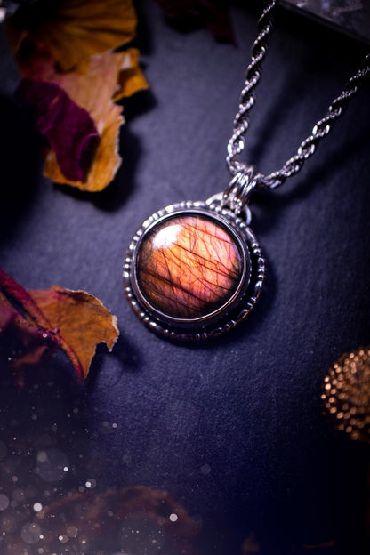 Beautifully handmade, dainty purple, orange, and pink sunset Labradorite spectrolite pendant necklace. This circular labradorite is full of stunning colour and patterns which has been made into a pendant using recycled sterling silver. Crystal gift