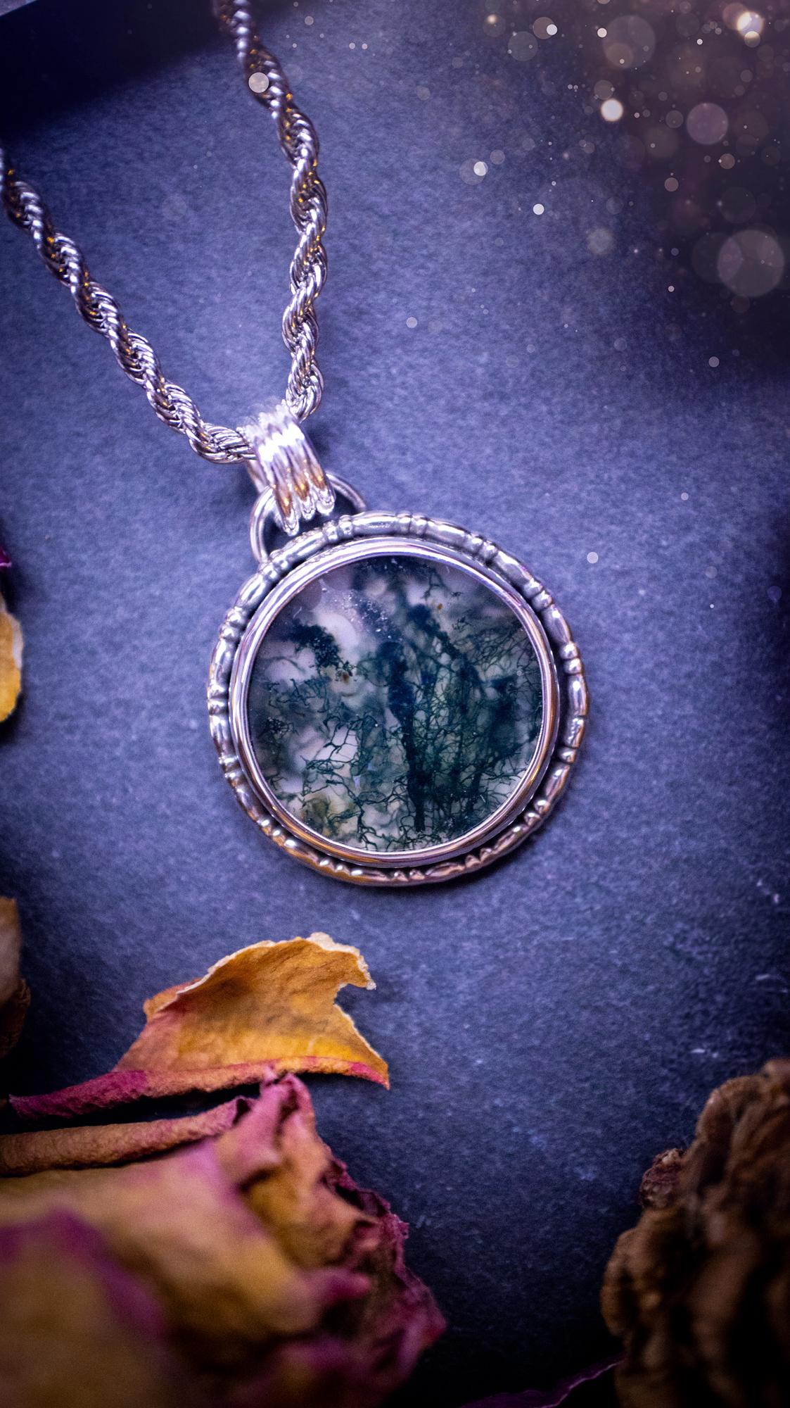 Beautifully handmade, dainty, moss agate crystal pendant necklace. This circular moss agate is full of stunning colour and patterns which has been made into a pendant using recycled sterling silver. Crystal gifts, gothic and hippy jewellery.