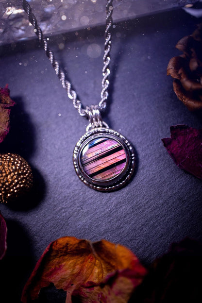 Beautifully handmade, dainty purple, orange, and pink sunset Labradorite spectrolite pendant necklace. This circular labradorite is full of stunning colour and patterns which has been made into a pendant using recycled sterling silver. Crystal gift