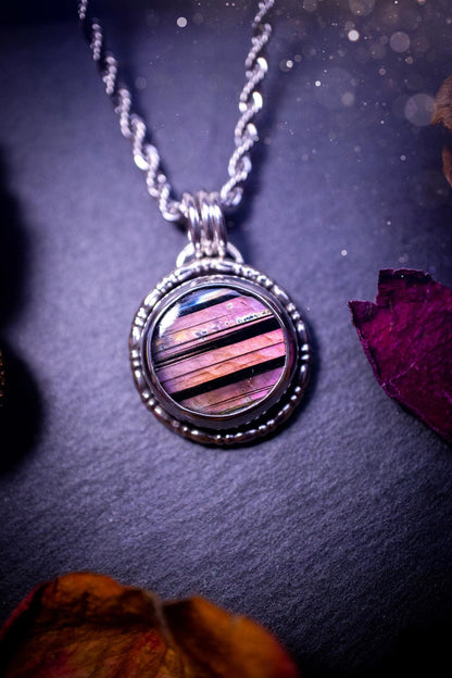 Beautifully handmade, dainty purple, orange, and pink sunset Labradorite spectrolite pendant necklace. This circular labradorite is full of stunning colour and patterns which has been made into a pendant using recycled sterling silver. Crystal gift