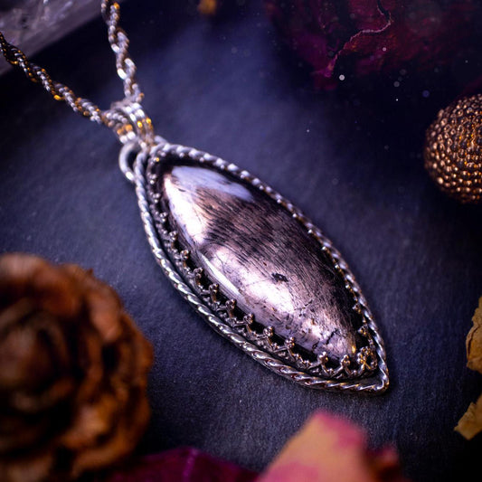 Beautifully handmade, and natural hypersthene crystal, sterling silver pendant necklace. This stunning pendant necklace features a marquise shaped hypersthene crystal gemstone that is full of shimmering silver flash. Rocking a minimalistic design with a gallery wire bezel to give off gothic and witchy vibes. This piece would be ideal as a gift for any jewellery and crystal lover, or even for yourself as a treat.
