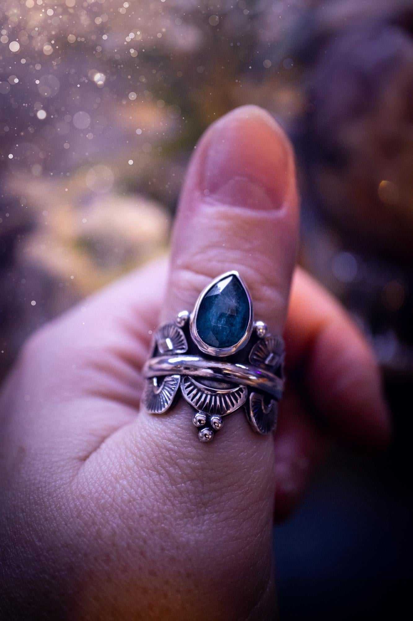 Beautiful and one of a kind, deep blue aqua kyanite crystal, statement ring. Size O 1/2. This stunning and unique ring has been handmade using a high grade kyanite crystal. The kyanite is rose cut giving a gorgeous sparkle, it even has a little shimmering flash. Made from recycled fine and sterling silver and designed with different stamps on a wide band. A very pretty piece to gift to a loved one or to treat yourself. Bohemian, gothic and witchy crystal jewellery.