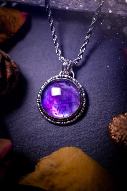 Beautifully handmade, and a one of a kind piece, mother of pearl and amethyst doublet, sterling silver pendant necklace. This pendant features the most beautiful MOP and amethyst doublet that is full of dreamy rainbows with a stunning purple hue. The pendant has been crafted using recycled fine and sterling silver, with a minimalistic design and fancy gallery wire around the circular bezel. This piece is ideal for crystal and jewellery lovers, giving hippy and mermaid vibes.