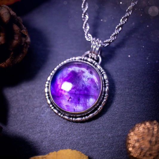 Beautifully handmade, and a one of a kind piece, mother of pearl and amethyst doublet, sterling silver pendant necklace. This pendant features the most beautiful MOP and amethyst doublet that is full of dreamy rainbows with a stunning purple hue. The pendant has been crafted using recycled fine and sterling silver, with a minimalistic design and fancy gallery wire around the circular bezel. This piece is ideal for crystal and jewellery lovers, giving hippy and mermaid vibes.