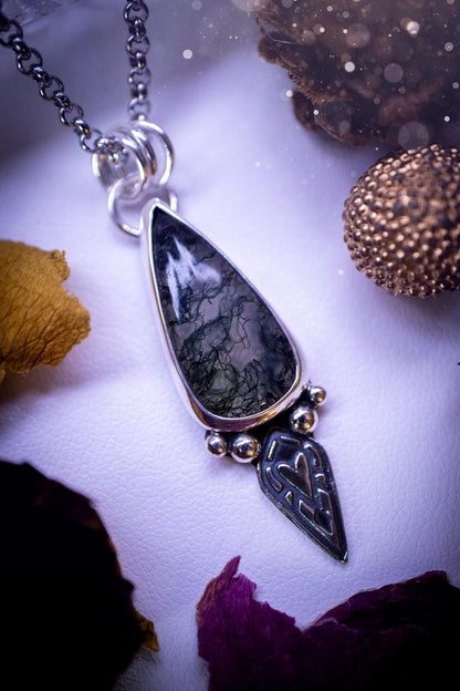 Handmade and one of a kind, &#39;heart of the wild&#39; Moss agate crystal pendant necklace. This pendant necklace has been design and handmade from scratch, made from recycled fine and sterling silver. Featuring the moss beautiful and natural Moss agate crystal, with an open back on the pendant so you can see through the stone revealing all the beautiful mossy patterns. On the pendant is sterling silver ball components with a heart of the wild stamp, ideal gift for her, witchy and gothic jewell