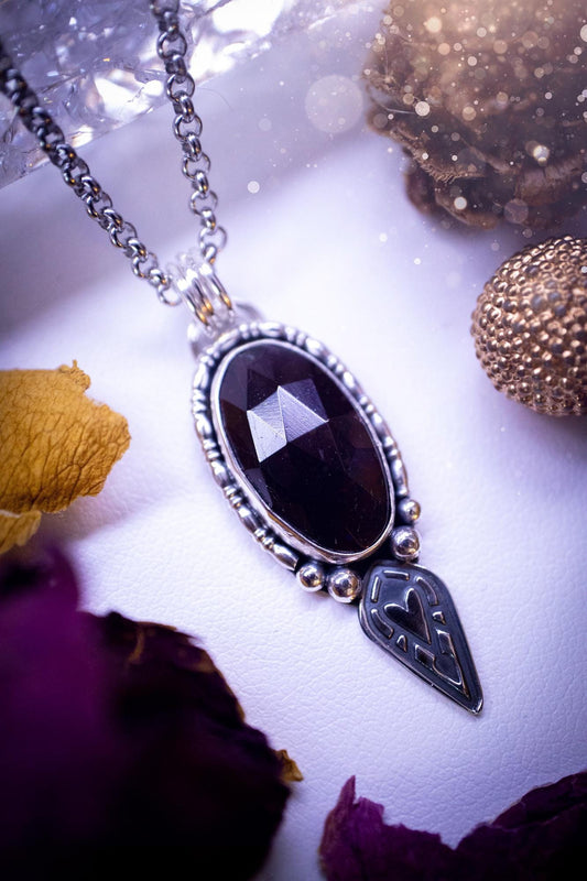 Handmade and one of a kind, &#39;heart of the wild&#39; garnet crystal pendant necklace. This pendant necklace has been design and handmade from scratch, made from recycled fine and sterling silver. Featuring the most beautiful and natural garnet crystal, the crystal is a deep dark red with pink hues, but can look nearly black from some angles. On the pendant is sterling silver ball components with a heart of the wild stamp, ideal gift for her, witchy and gothic jewellery.