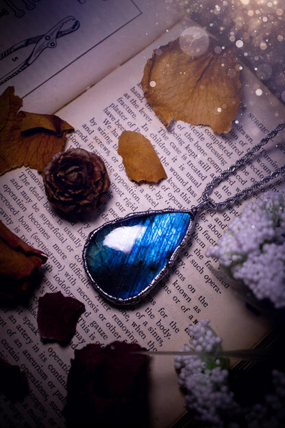 A beautiful, one of a kind, green and blue Labradorite crystal pendant necklace. This pendant has been handmade using the soft solder method, also known as the tiffany technique used to create stained glass windows. Featuring the most stunning and natural Labradorite crystal which is full of blue and green hues. The  pendant is suitable for gifting to any jewellery or crystal lover, or to simply add to your own collection. One of a kind jewellery, gothic and witchy gifts