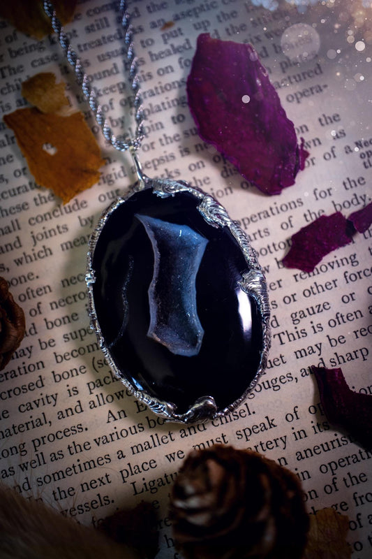 Beautiful and handcrafted, black druzy agate, crystal pendant necklace. This one of a kind piece of jewellery has been hand made using the tiffany technique, also known as soft soldering. The bezel is made with a solder that is lead free and contains elements of silver so when polished a high lustre is achieved. Featuring a large druzy agate with beautiful sparkle and banding. This is the ideal gift for any crystal or jewellery lover that likes a gothic and witchy vibe and aesthetic.