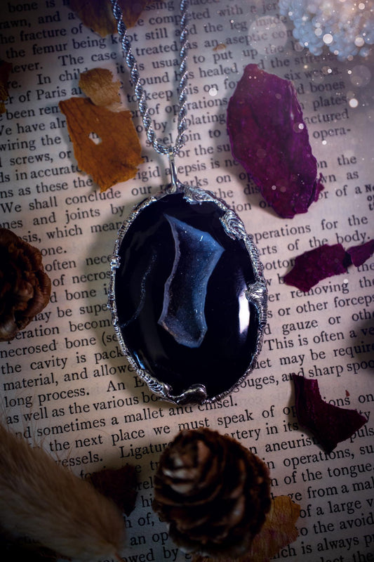 Beautiful and handcrafted, black druzy agate, crystal pendant necklace. This one of a kind piece of jewellery has been hand made using the tiffany technique, also known as soft soldering. The bezel is made with a solder that is lead free and contains elements of silver so when polished a high lustre is achieved. Featuring a large druzy agate with beautiful sparkle and banding. This is the ideal gift for any crystal or jewellery lover that likes a gothic and witchy vibe and aesthetic.