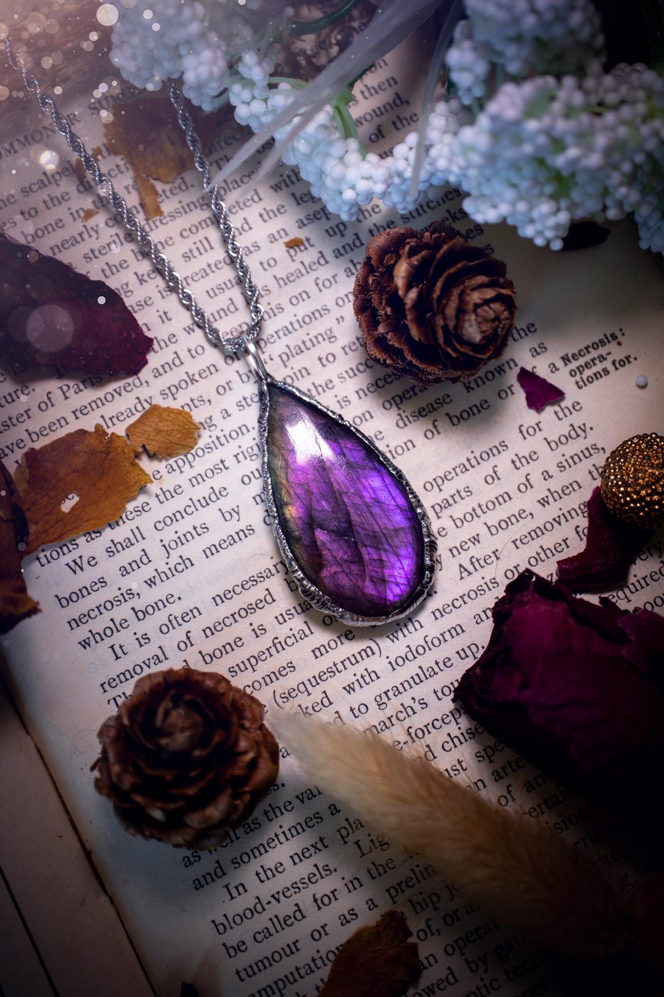A beautiful, one of a kind, purple, green and grey multi-flash Labradorite crystal pendant necklace. This pendant has been handmade using the soft solder method, also known as the tiffany technique used to create stained glass windows. Featuring the most stunning and natural Labradorite crystal which is full of purple and green hues. The  pendant is suitable for gifting to any jewellery or crystal lover, or to simply add to your own collection. One of a kind jewellery, gothic and witchy gifts