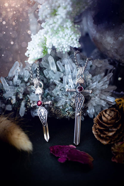 Handmade sterling silver pendant necklace in the shape of a sword, featuring a beautiful garnet as the centre piece. This piece of jewellery has been created using recycled fine and sterling silver and features a gorgeous garnet that is full of sparkle. Suitable or special occasions such as birthdays, anniversaries, graduations and more. Garnet is the birthstone for January. Witchy and gothic handmade jewellery, medieval.