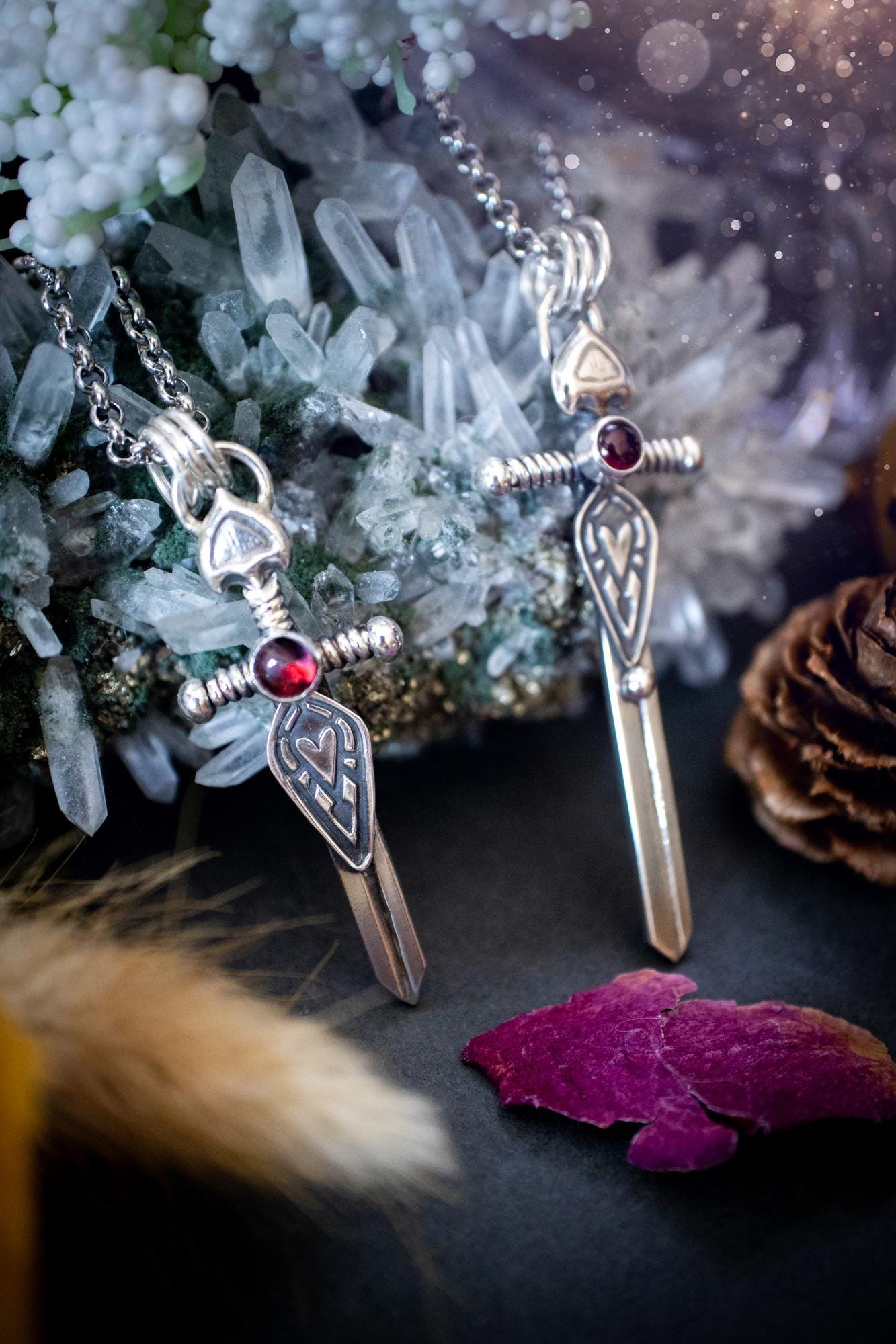Handmade sterling silver pendant necklace in the shape of a sword, featuring a beautiful garnet as the centre piece. This piece of jewellery has been created using recycled fine and sterling silver and features a gorgeous garnet that is full of sparkle. Suitable or special occasions such as birthdays, anniversaries, graduations and more. Garnet is the birthstone for January. Witchy and gothic handmade jewellery, medieval.