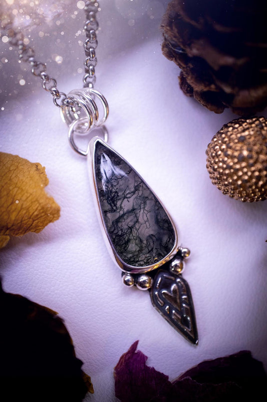 Handmade and one of a kind, &#39;heart of the wild&#39; Moss agate crystal pendant necklace. This pendant necklace has been design and handmade from scratch, made from recycled fine and sterling silver. Featuring the moss beautiful and natural Moss agate crystal, with an open back on the pendant so you can see through the stone revealing all the beautiful mossy patterns. On the pendant is sterling silver ball components with a heart of the wild stamp, ideal gift for her, witchy and gothic jewell