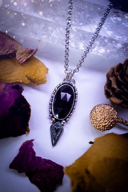 Handmade and one of a kind, &#39;heart of the wild&#39; garnet crystal pendant necklace. This pendant necklace has been design and handmade from scratch, made from recycled fine and sterling silver. Featuring the most beautiful and natural garnet crystal, the crystal is a deep dark red with pink hues, but can look nearly black from some angles. On the pendant is sterling silver ball components with a heart of the wild stamp, ideal gift for her, witchy and gothic jewellery.