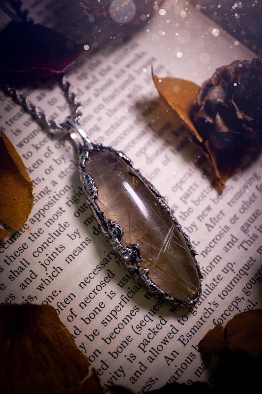 Handcrafted and unique, golden rutile quartz crystal, soft soldered pendant necklace. This pendant necklace has been handcrafted using the soft soldering method, also known as the tiffany technique. This method uses lead free solder which contains elements of silver for a high polish. This pendant features the most gorgeous and high quality, gold rutile quartz full of golden stripes with high clarity. Ideal gift for crystal and jewellery lovers. Witchy and gothic jewellery gifts for her.