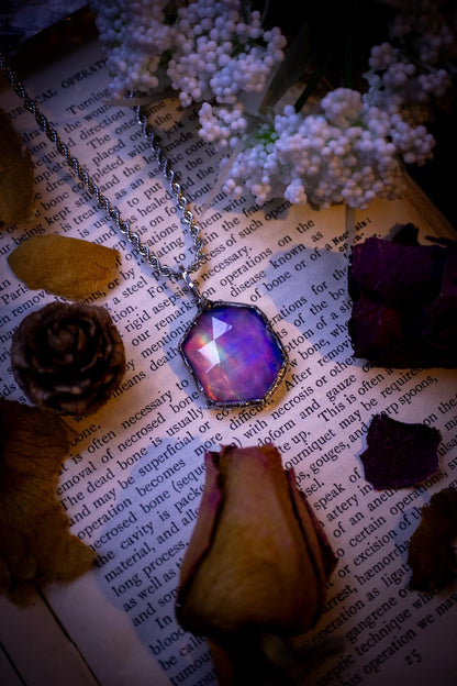 A beautiful, one of a kind, aurora opal pendant necklace. This little statement necklace is handmade using the tiffany technique, also known as soft soldering. Featuring the most stunning, and sparkly aurora opal which is full of pinks, greens and blues just like the northern lights. Aurora opals are man made opals that look similar to natural ones, they have a layer of rose quartz on top to give extra shine. The ideal gift for any crystal or jewellery lover. Gothic and witchy jewellery