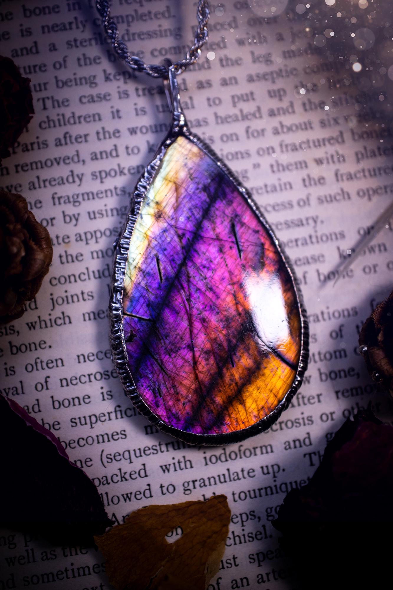 The ultimate labradorite soft soldered pendant necklace. This pendant necklace features the most beautiful and natural Labradorite spectrolite crystal that has so many hues of silver, purple, pink and orange. Handmade using the tiffany technique, also known as soft soldering. This piece is made from solder which contains metals and silver and is safe to wear. The ideal gift for any jewellery lover and crystal collector! Witchy, gothic and hippy jewellery that has been made for the soul.