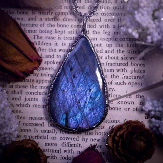 The ultimate labradorite soft soldered pendant necklace. This pendant necklace features the most beautiful and natural Labradorite spectrolite crystal that has so many hues of pastel blue and purples. Handmade using the tiffany technique, also known as soft soldering. This piece is made from solder which contains metals and silver and is safe to wear. The ideal gift for any jewellery lover and crystal collector! Witchy, gothic and hippy jewellery that has been made for the soul.