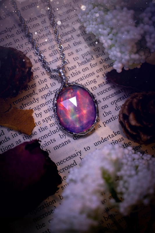 A beautiful, one of a kind, aurora opal pendant necklace. This little statement necklace is handmade using the tiffany technique, also known as soft soldering. Featuring the most stunning, and sparkly aurora opal which is full of pinks, greens and blues just like the northern lights. Aurora opals are man made opals that look similar to natural ones, they have a layer of rose quartz on top to give extra shine. The ideal gift for any crystal or jewellery lover. Gothic and witchy jewellery