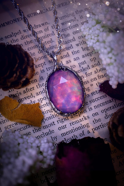 A beautiful, one of a kind, aurora opal pendant necklace. This little statement necklace is handmade using the tiffany technique, also known as soft soldering. Featuring the most stunning, and sparkly aurora opal which is full of pinks, greens and blues just like the northern lights. Aurora opals are man made opals that look similar to natural ones, they have a layer of rose quartz on top to give extra shine. The ideal gift for any crystal or jewellery lover. Gothic and witchy jewellery